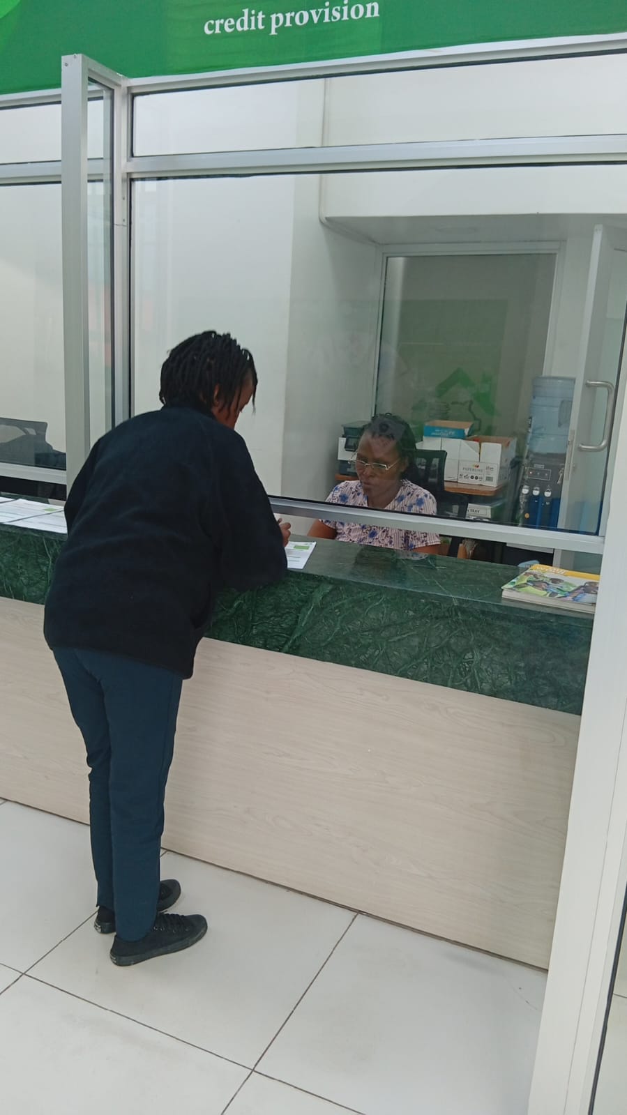 Customer being served at Unga Sacco counter